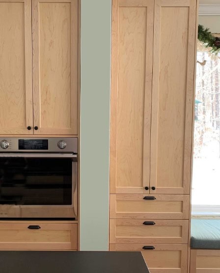 ink toned maple stain on cabinets with green accent color on walls
