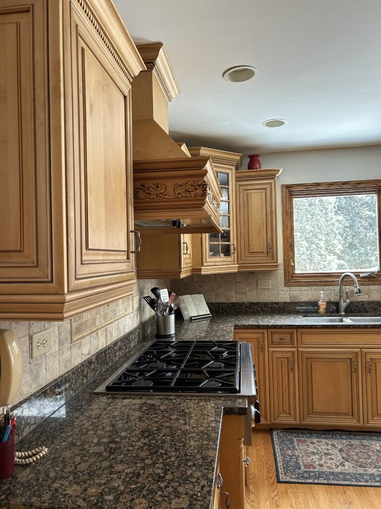 2000s tuscan style kitchen, orange and green granite, travertine tile backsplash, maple cabinets, oak wood trim and floor. Baltic Brown
