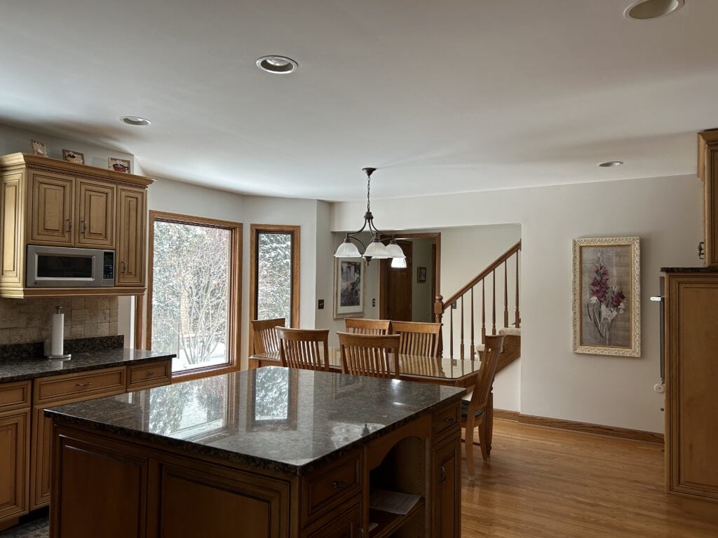Balboa Mist, kitchen with granite countertops, oak floor, wood maple cabinets, oak window trim, stair railing.