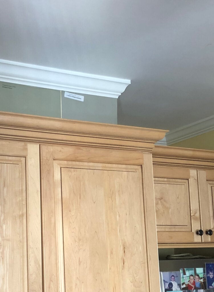 Benjamin Moore Cheyenne Green and Herbal Escape above light maple kitchen cabinets