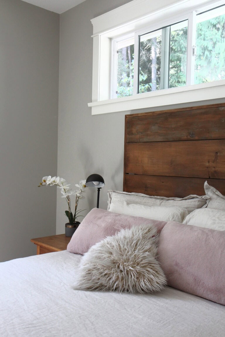 Benjamin moore Revere Pewter in bedroom with rustic wood headboard, dusty rose pink accents, Cloud White trim