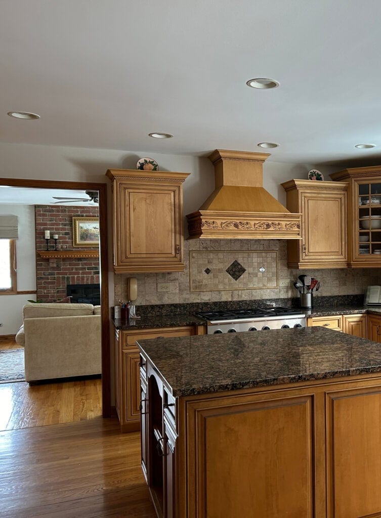 Mediterranean, warm tuscan style kitchen from early 2000s, maple glazed cabinets, Baltic Brown granite countertop, travertine tile backsplash, warm gray paint color on walls, wood trim