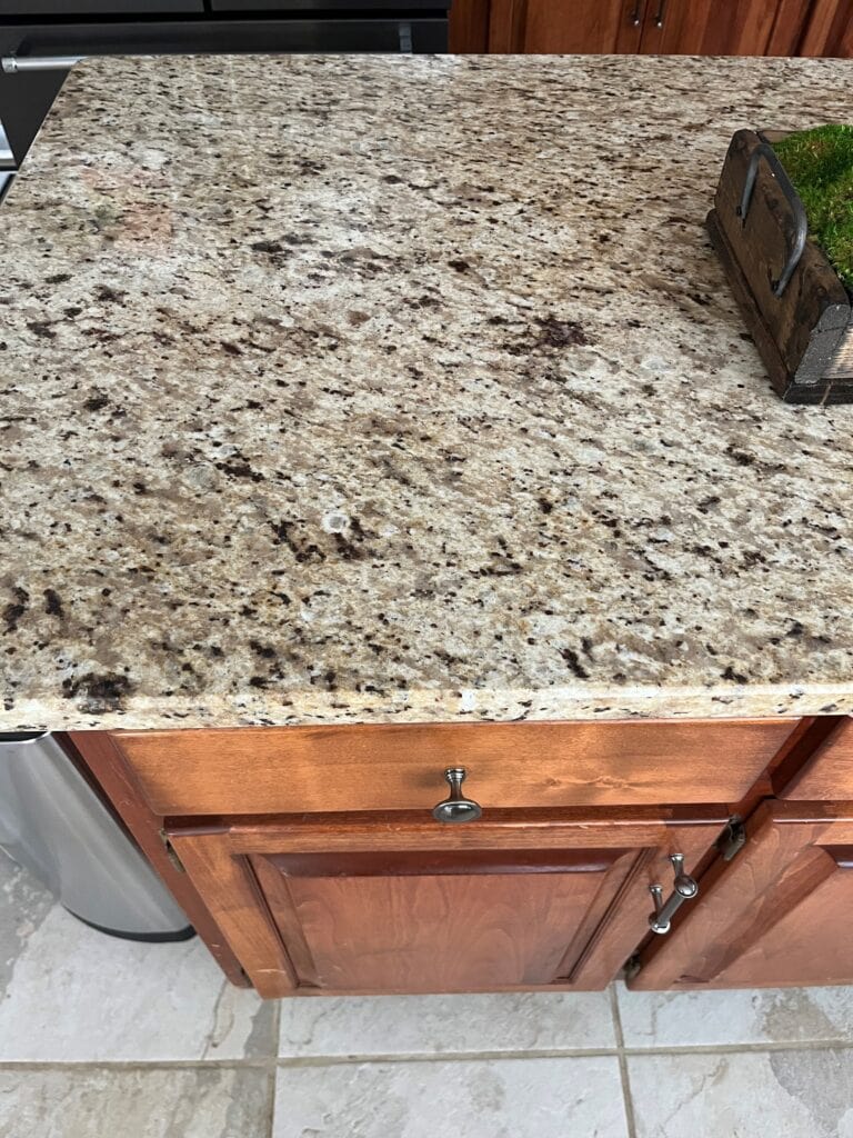 Santa Cecilia granite countertop, similar to Giallo Ornamental, common in Mediterranean or tuscan style homes in 2000s and 1990