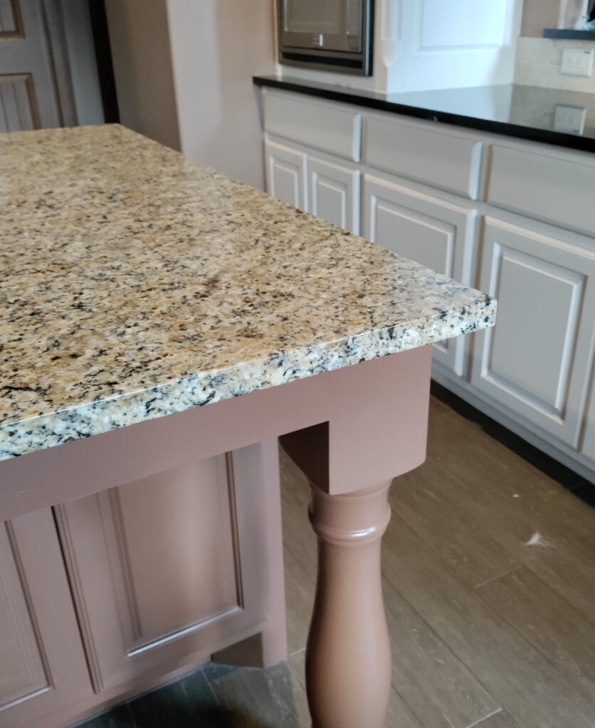 Santa Cecilia granite countertop with brown-taupe-pink-rose colored painted island and off-white cabinets