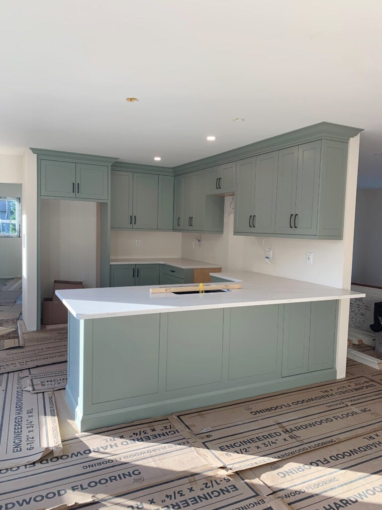 Sherwin Williams Evergreen Fog, painted green cabinets, sage green, white quartz countertpo in kitchen
