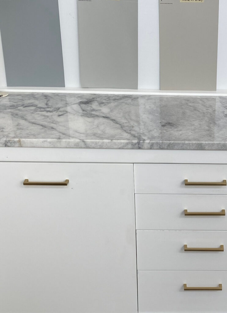 Sherwin Williams Network Gray, Gray Clouds, Mindful Gray, Amazing Gray, Worldly Gray, marble countertop in home office with white cabinet and beige-taupe carpet