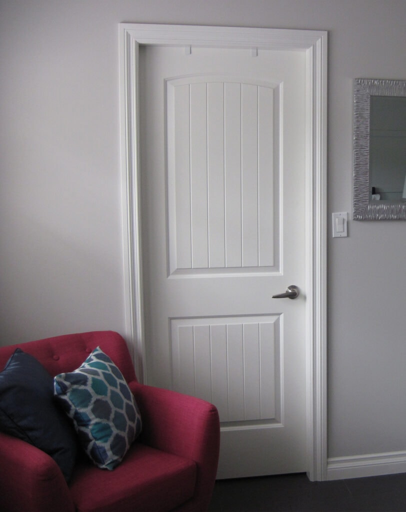 Sherwin Williams On the Rocks gray paint color on the walls with Benjamin Moore Simply White and red accent chair