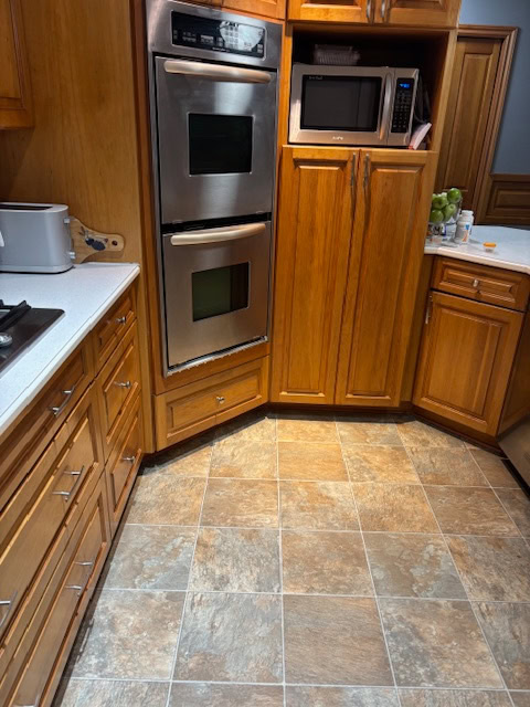 before update, vinyl linoleum kitchen flooring, cherry wood stained kitchen cabinets