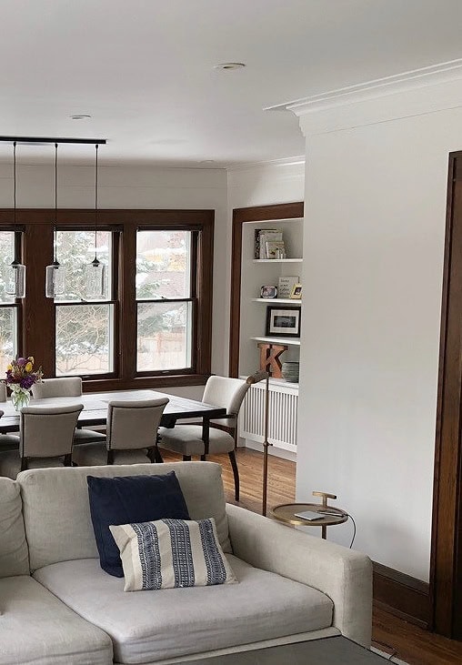 warm white walls similar to Benjamin Moore White Dove with dark wood trim in heritage home with window trims and wood floor