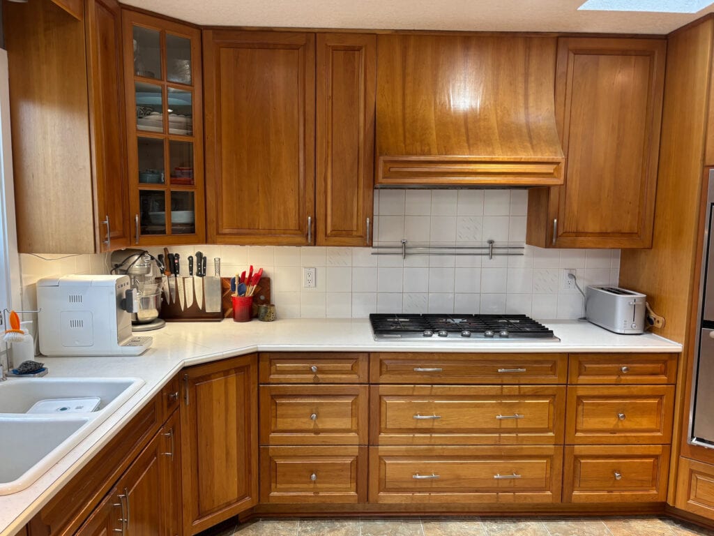BEFORE UPDATE IDEAS, kitchen aged or darkened cherry wood cabinets, vinyl linoleum floor, off white laminate countertop