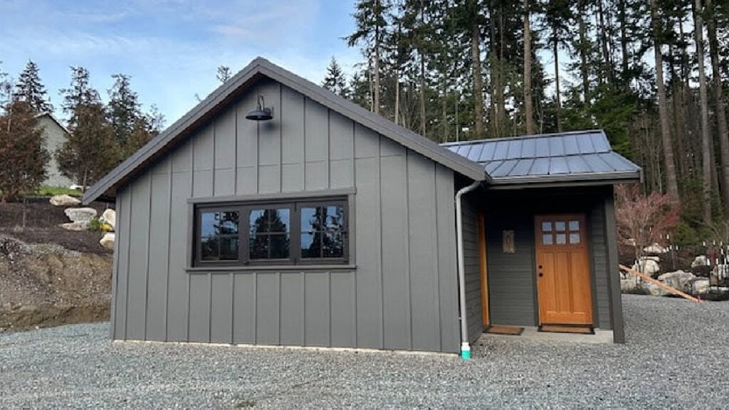 Benjamin Moore Kendall Charcoal on an exterior with Iron Ore trim and a dark metal roof and black windows