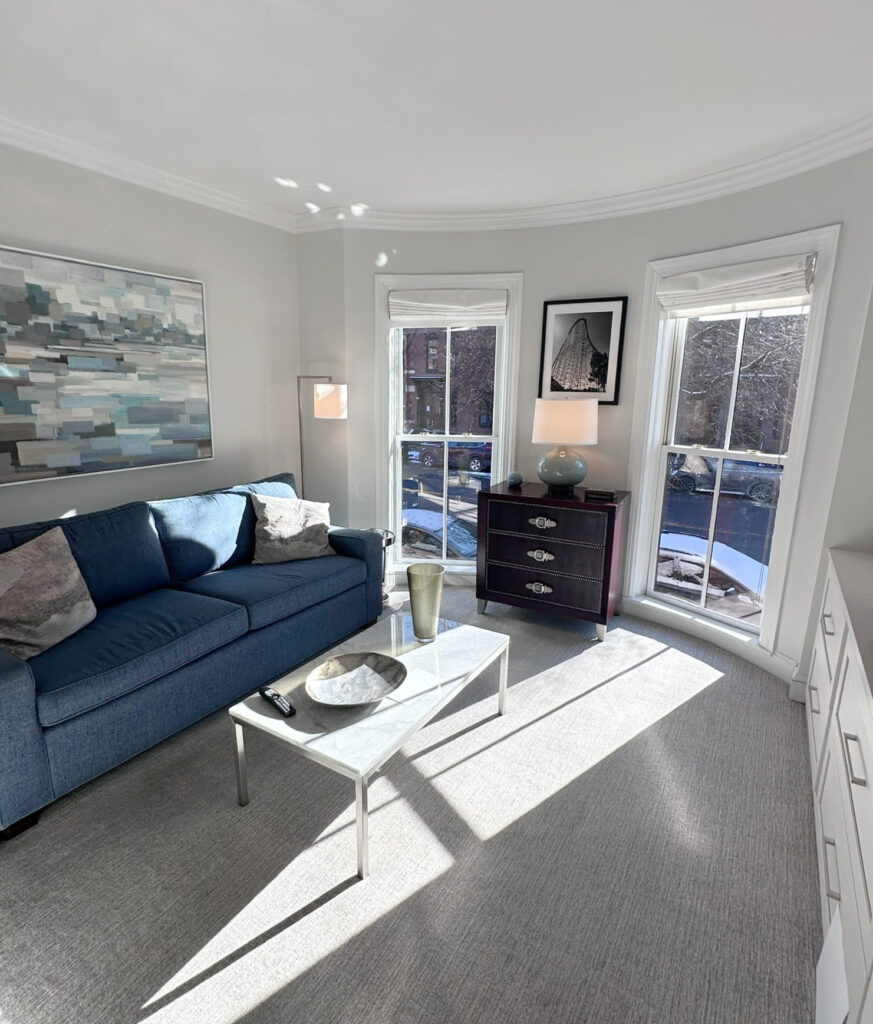 Den with built-ins, LInen by California Closets, gray carpet, blue sofa, Benjamin Moore Paper White walls, White OC 151 trim, south facing (1)