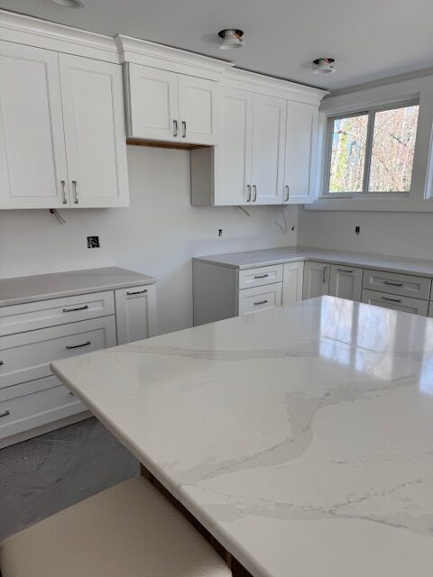 Kraftmaid Frost (white) kitchen cabinets and Silestone Et Calacatta Gold white quartz countertop