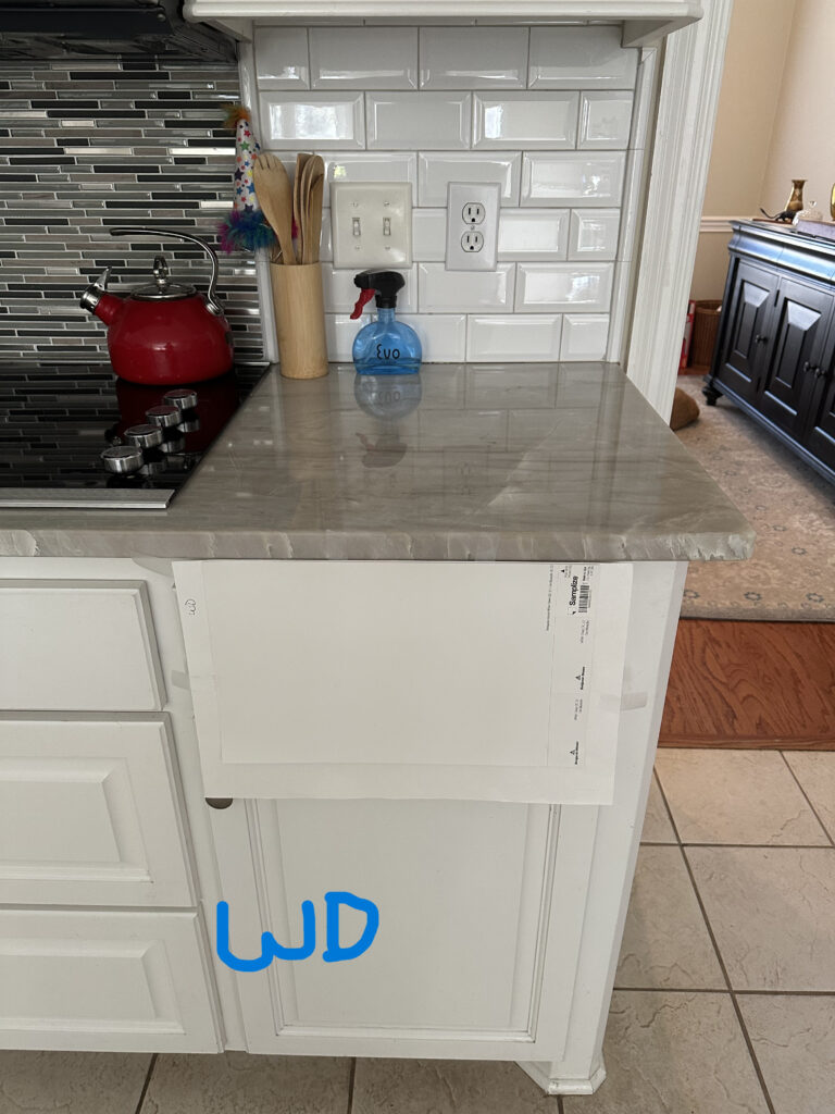 Taj Mahal quartzite countertop in kitchen with Benjamin MOore White Dove, warm white paint color