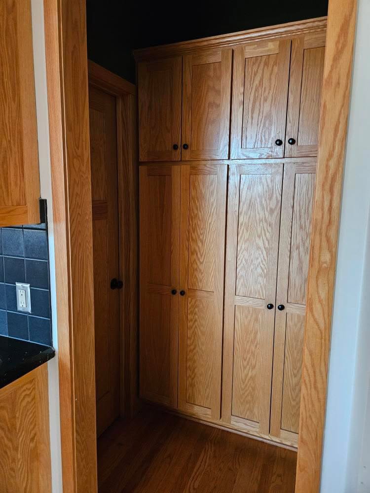 oak kitchen cabinets in pantry with wood trim