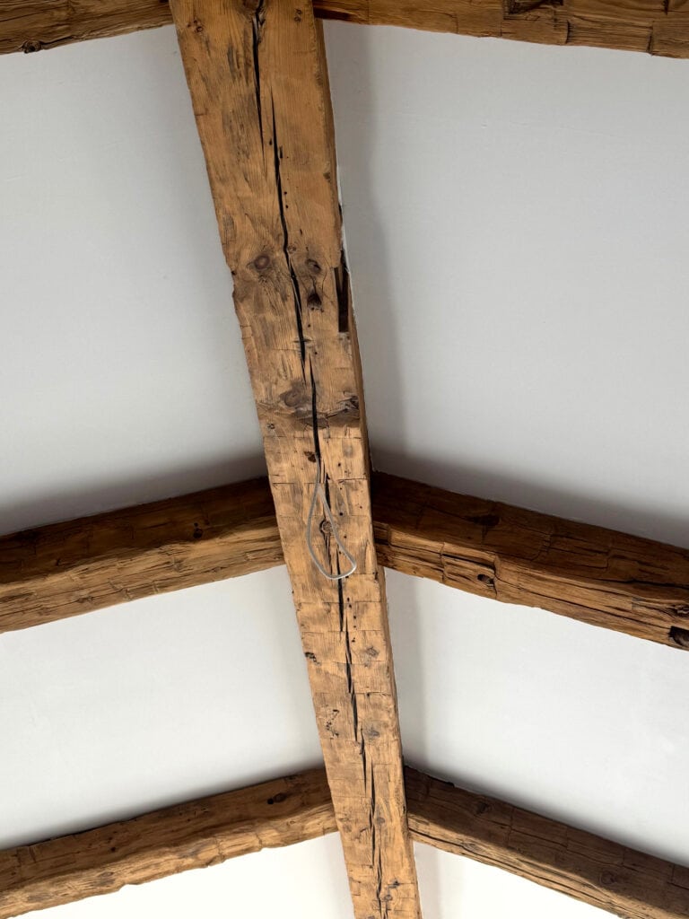 rustic natural wood beams on primary bedrom ceiling or living room