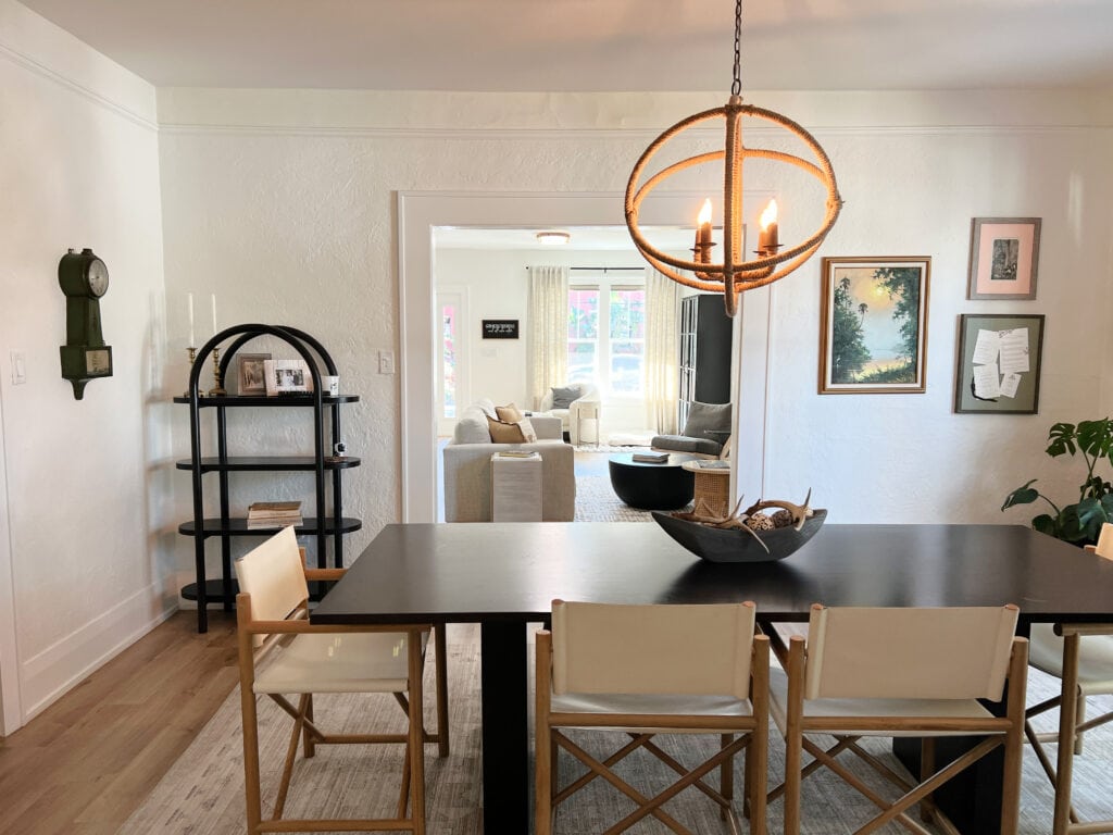 shotgun style home, textured walls, dining room in Sherwin Williams Greek Villa lightened, Extra White trim, livingroom throuh doorway, dark wood, oak floor