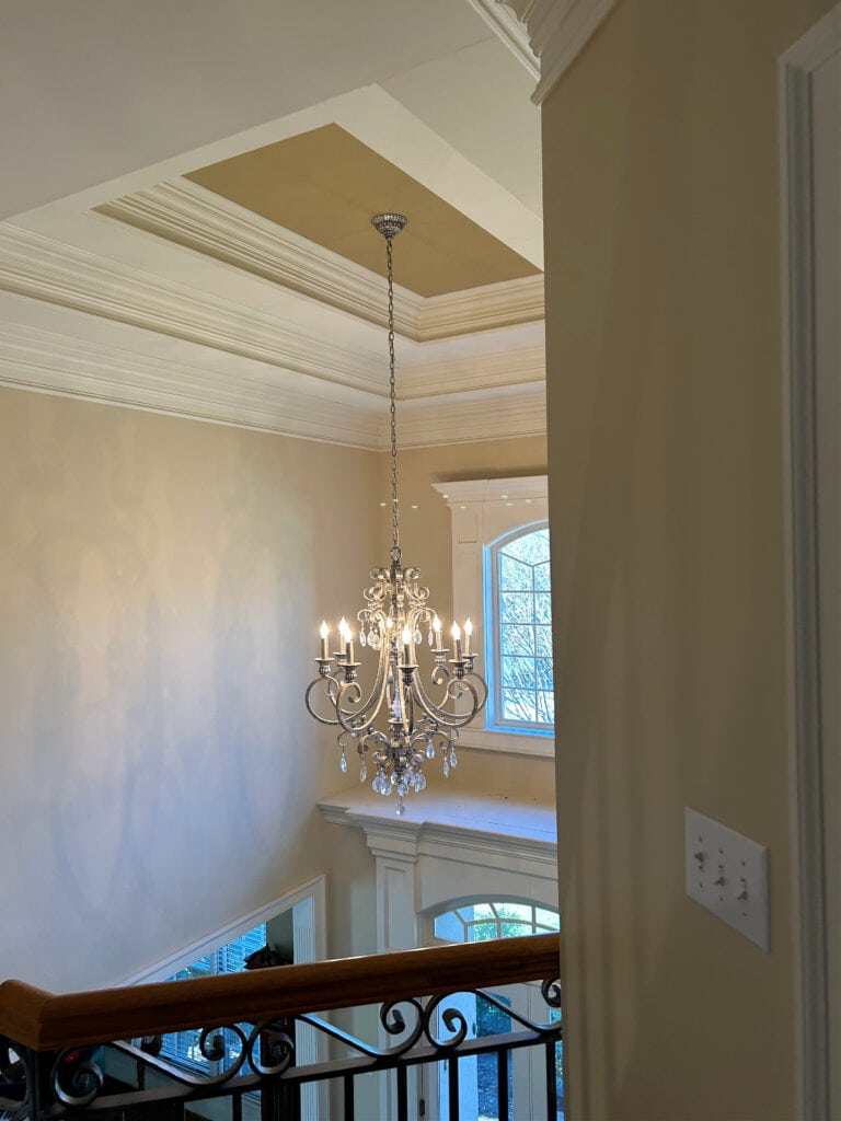 tray ceiling with levels of molding, crystal chandelier, 2000s
