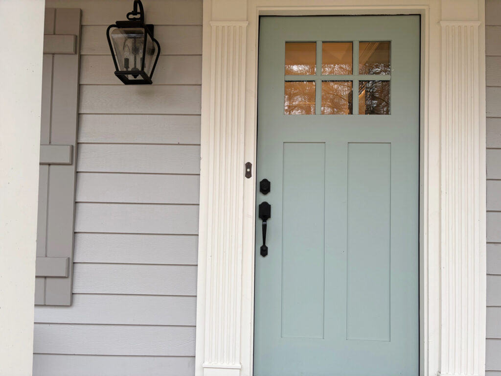 Exterior painting Benjamin Moore Smoke Embers, Dovetail shuttesr, off-white trim and Wythe Blue front door