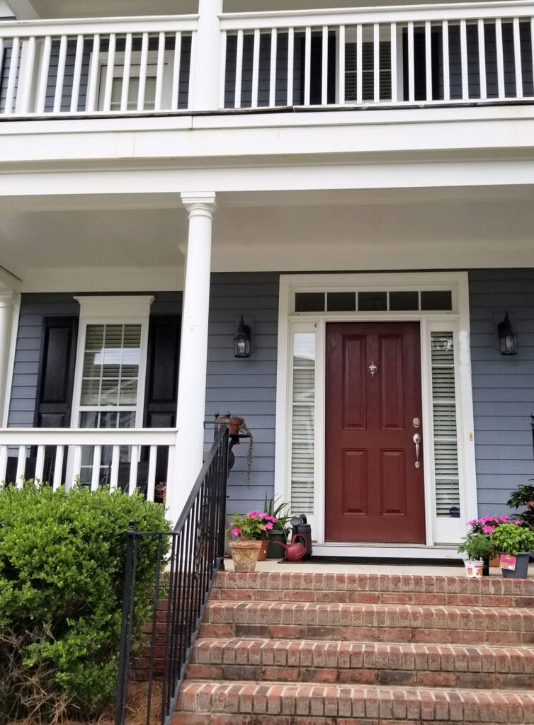 Sherwin Williams Downing Slate siding, Rookwood Dark Red burgundy front door paitn color, pink brick, white trim, black shutters exterior