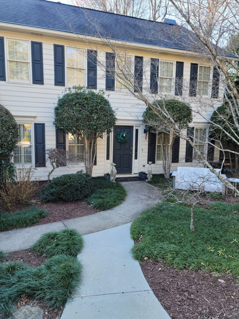 Benjamin Moore Ballet White exterior with dark soft black shutters, Nightfall, trim same as siding, gray roof