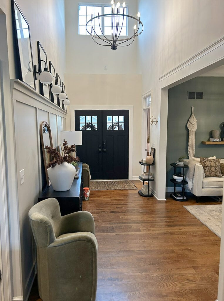 Benjamin Moore Chamois walls, Revere PEwter board and batten in entryway, dark oak wood floor, black front door, Sherwin Retreat green in den, home decor, transitional style