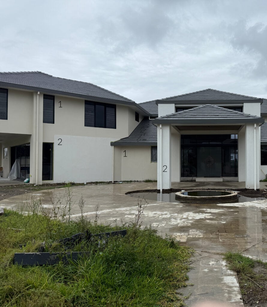 Sherwin Williams Accessible Beige and Aesthetic White on exterior in Australia, stucco, dark gray brown, taupe metal roof