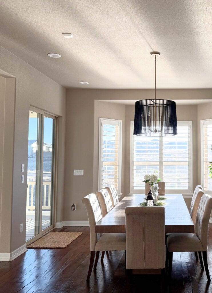 Sherwin Williams Balanced Beige in dining room, on walls and ceiling, dark wood floor