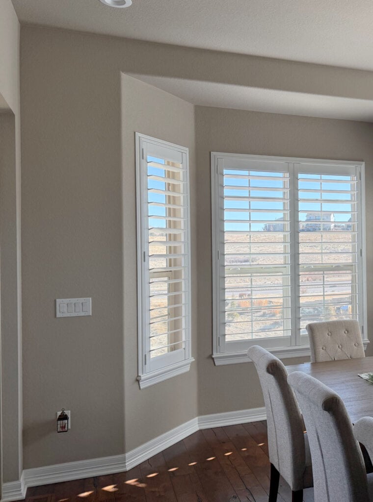 Sherwin Williams Balanced Beige paint color on walls and ceiling, white trim, dark wood floor