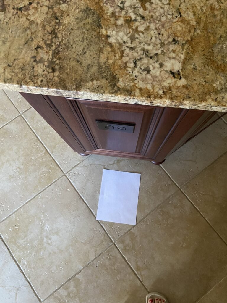 Sienna Typhoon Bordeaux granite countertop, gold, taupe, with beige tile floor and cherry cabinets (2)