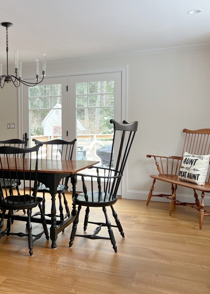 Wood floor in dining area, black modern farmhouse chairs, Sherwin Williams Aesthetic White beige on walls, Pure White trim