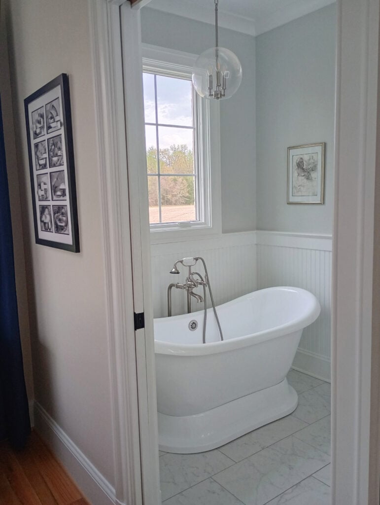 Bathroom, freestanding heritage look tub, marble look floor, Pure White wainscoting and trim, Silverpointe gray on walls by Sherwin Williams