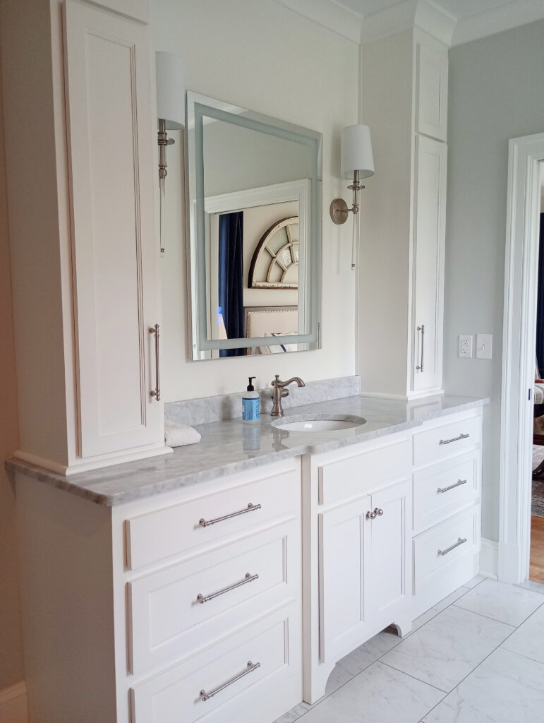 Bathroom vanity painted Sherwin Williams Pure White, Silverpointe walls, nickel and vintage nickel look hardware and faucet, marble look tile floor, marble countertop