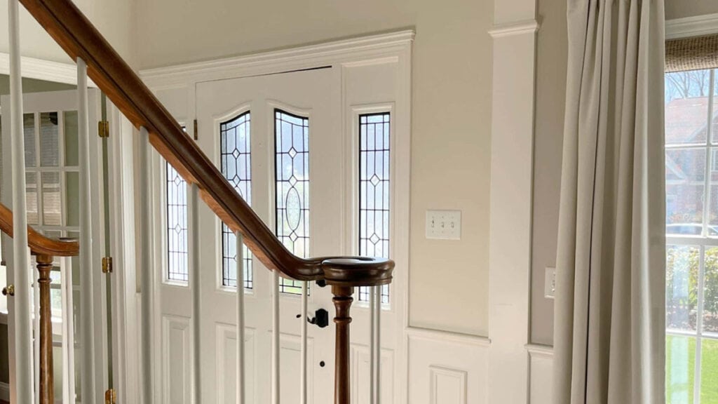 Benjamin Moore BAllet White in a 1990s entrywa with White Dove trim and front door