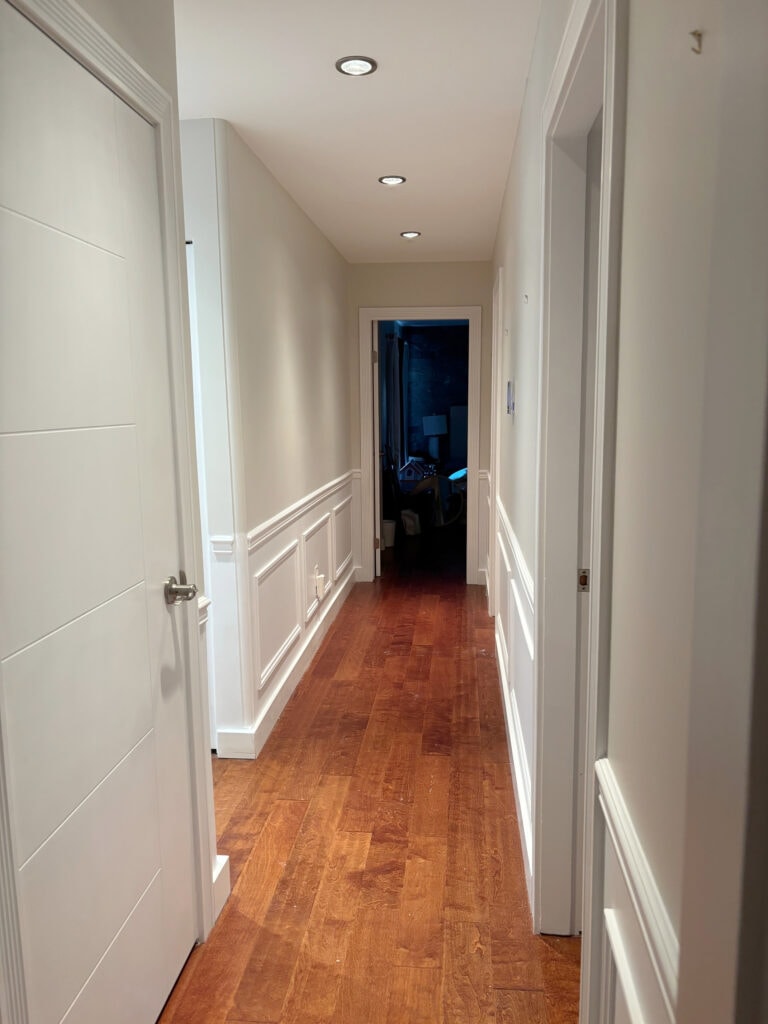 Benjamin Moore Classic Gray in dark hallway, wood flooring, white wainscoting Chantilly Lace or close to