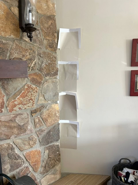 Brown, gold, beige, gray stone fireplace from 1970 and 1980, beige paint color samples