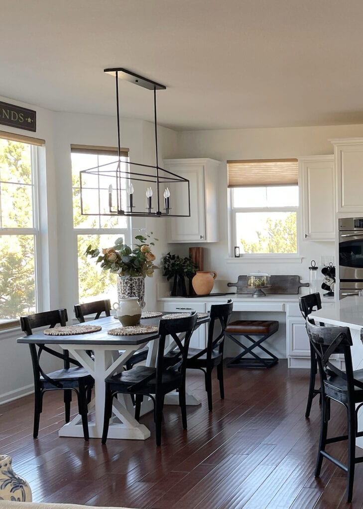 Dining area in kitchen, Sherwin Williams Pure White walls and painted cabinetse, dark wood floor red stain, home decor