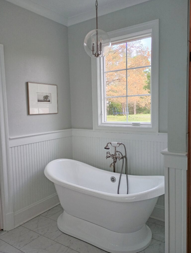 Freestanding bathtub in heritage home, Sherwin Williams Pure White beadboard and trim moldings, Silverpointe gray on the walls, chandelier, vintage, antique nickel look tub filler and faucet