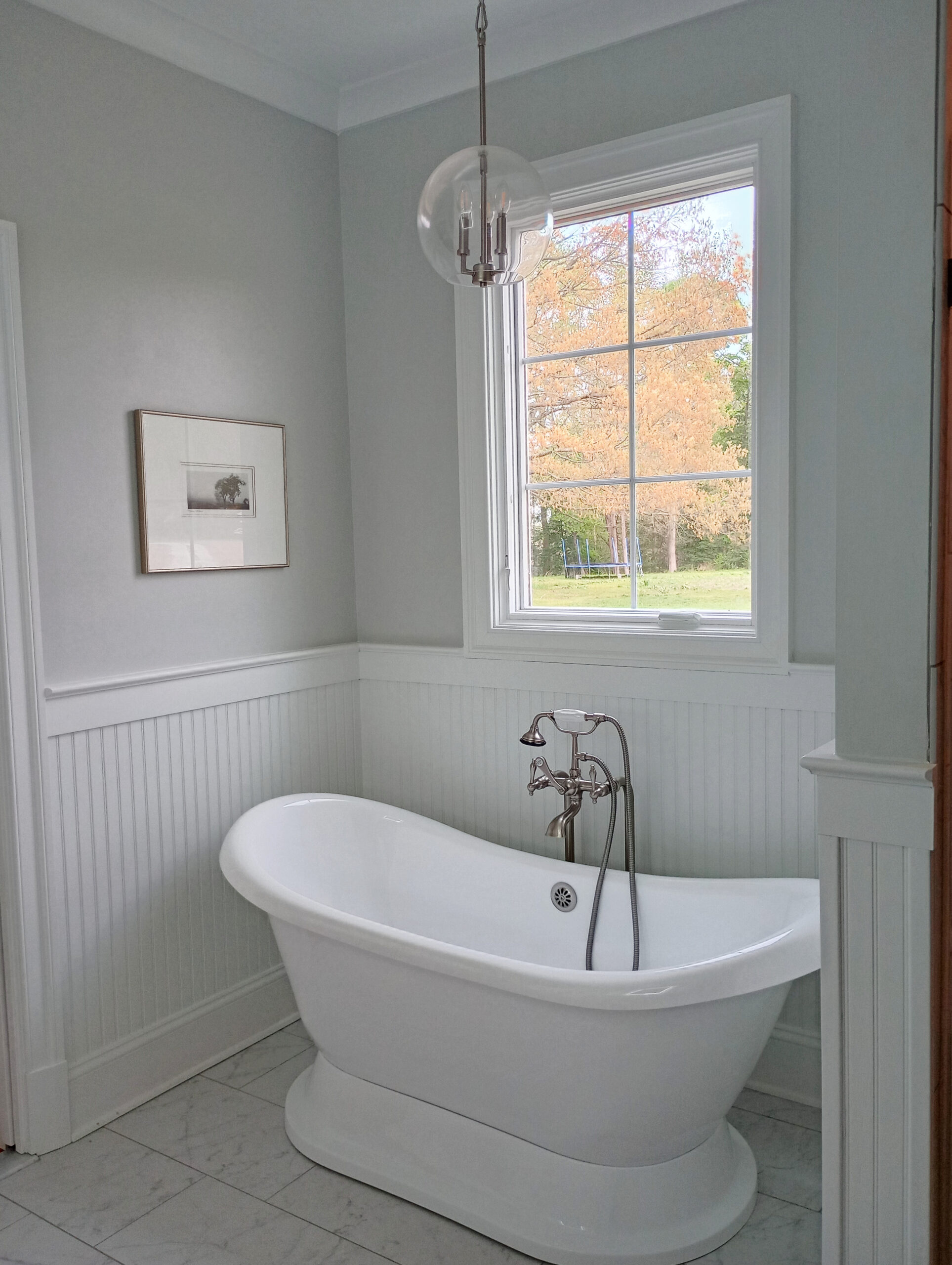 Freestanding bathtub in heritage home, Sherwin Williams Pure White beadboard and trim moldings, Silverpointe gray on the walls, chandelier, vintage, antique nickel look tub filler and faucet