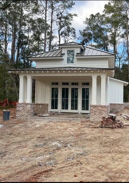 Guest house exterior, Benjamin Moore Swiss Coffee white siding, board and batten, Savannah brick, french doors