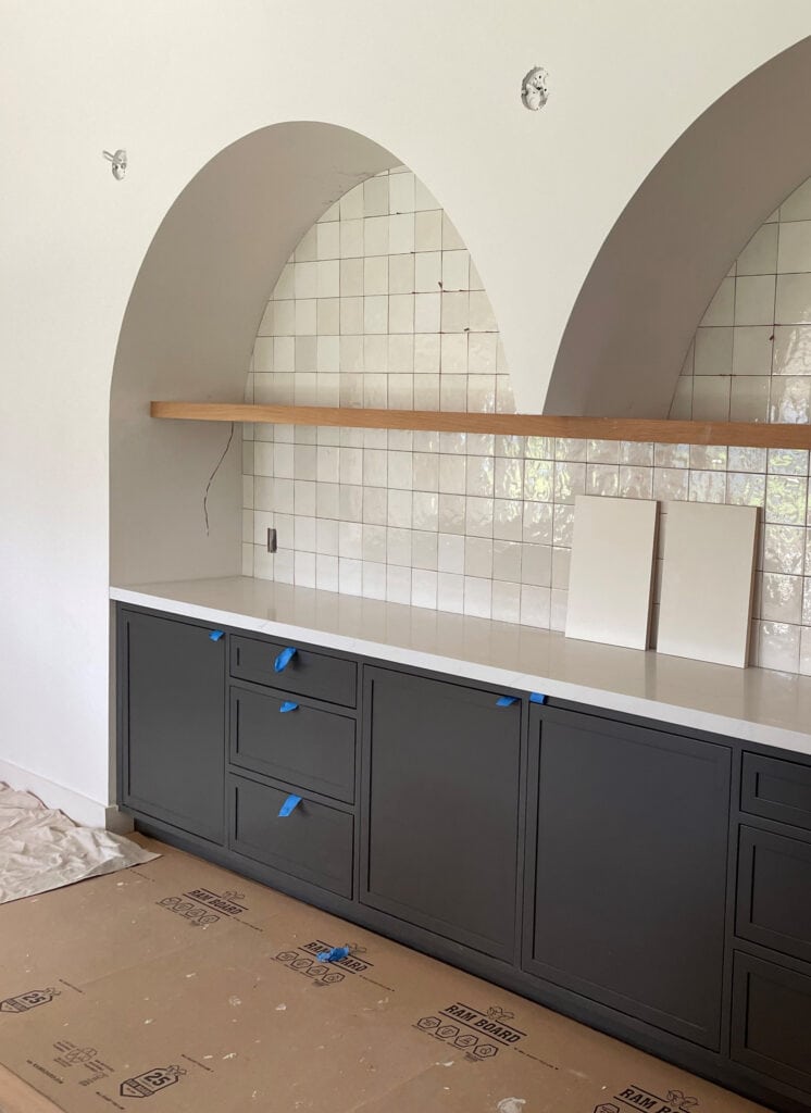 Home bar, built-in buffet with two drywall arches, wood floating shelve, square zellige tile, Sherwin Williams Iron ore, soft black cabinet color (1)