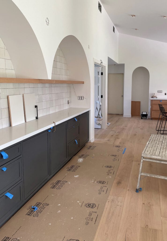 Kitchen with arches, bar area with arch, zellige tile, Sherwin Williams Iron Ore cabinets, white quarztz, white oak floor