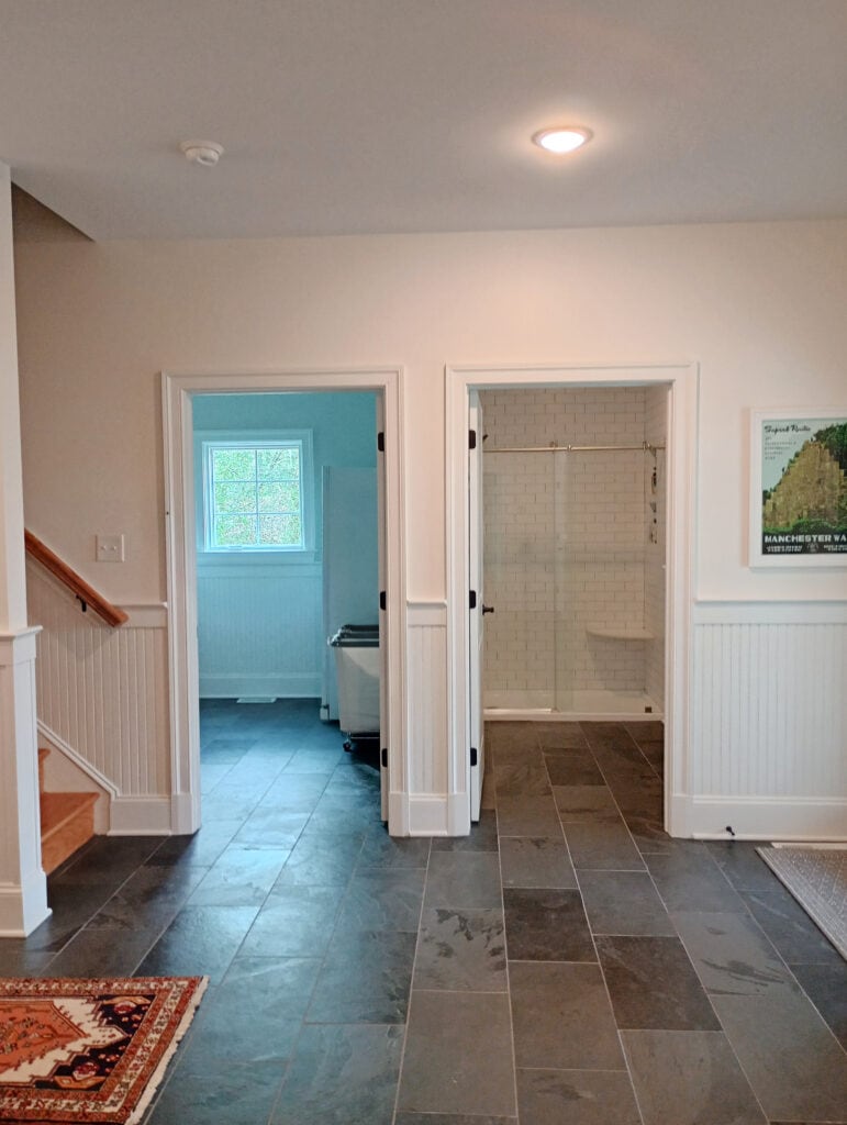 Mudroom, dark gray and black slate tile flooring, Sherwin Williams warm creamy white Alabaster walls, Pure White trim and beadboard moldings