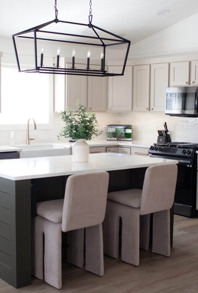 Sherwin Williams Balanced Beige painted wood kitchen cabinets, white quartz, zellige tile backsplash, black appliances, Thunder Gray island