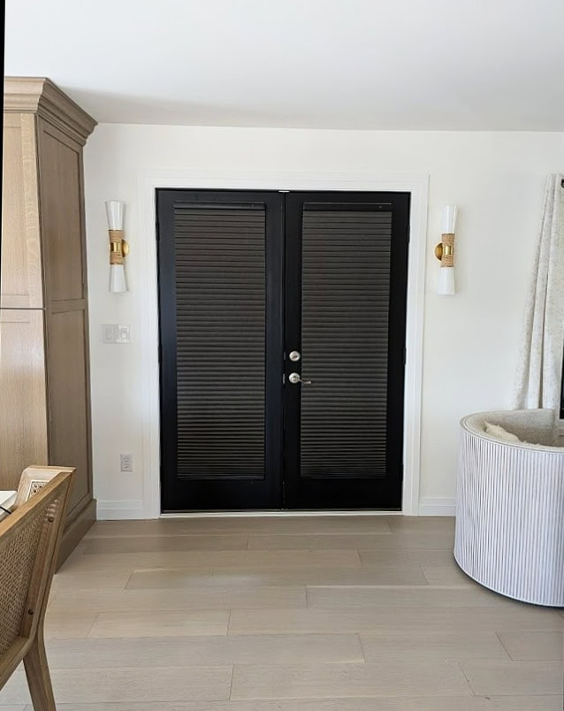 Sherwin Williams Cheviot, warm white in Emerald Designer Edition, pink, whitewashed oak floor, black french doors, Benjamin Moore Chantilly Lace trim, two whites go together