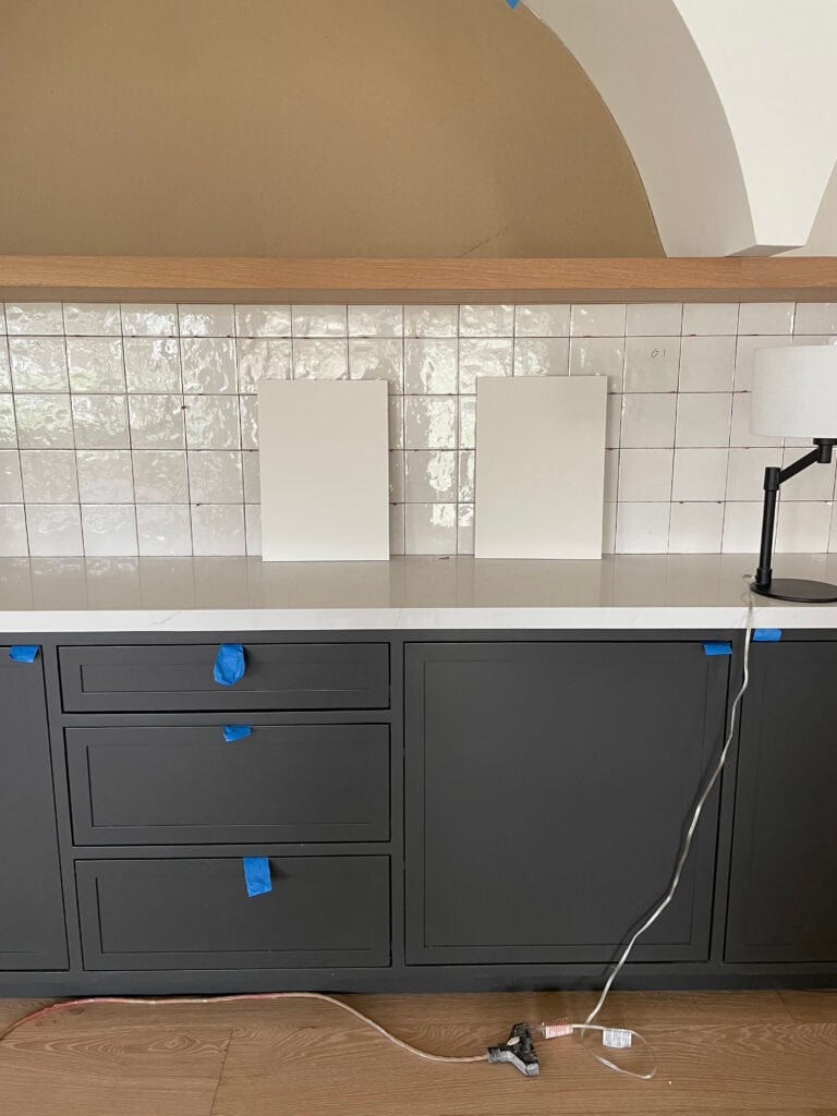 Sherwin Williams Iron Ore built in, soft black cabinets, white quartz, zellige tile, arches wood floating shelf in bar area, white oak