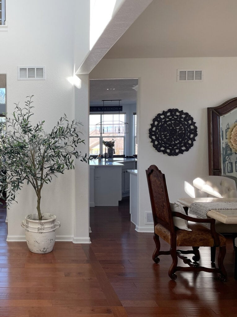 Sherwin Williams Pure White with red wood floor, tuscan style dining area
