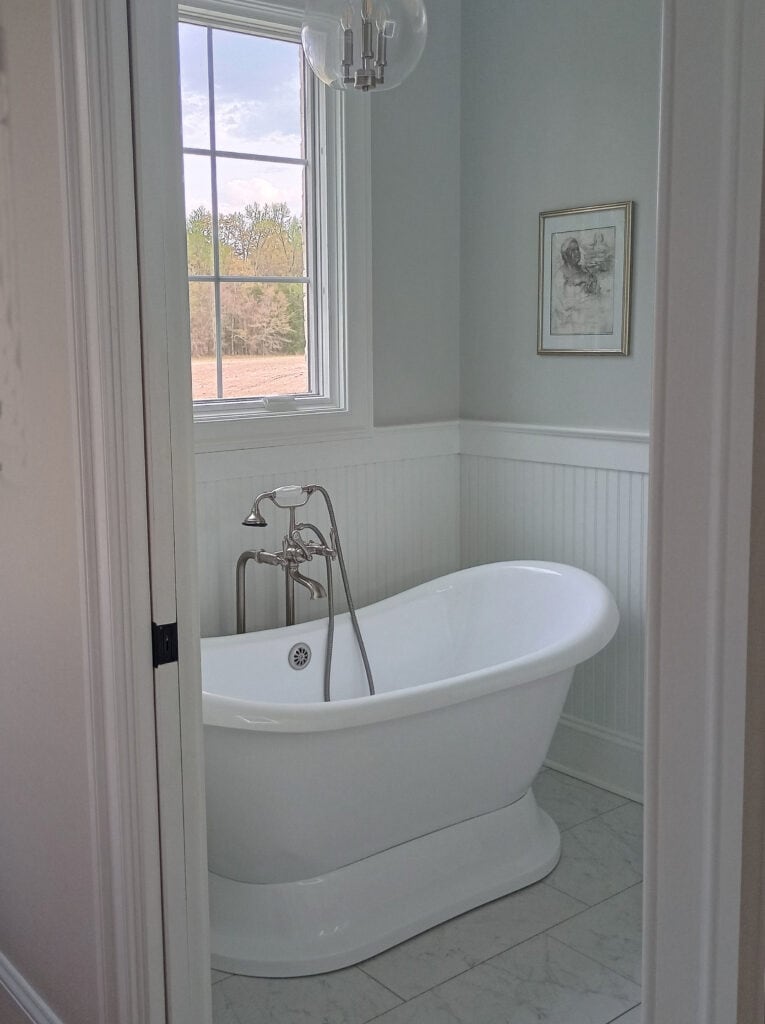 Sherwin Williams Silverpointe, gray paint color on walls, Pure White beadboard, trims, freestanding bathtub, window, marble look tile floor