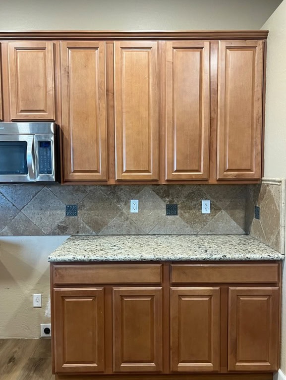 Santa Cecilia, similar to Giallo Ornamental older granite kitchen countertop with maple wood cabinets, travertine tile backsplash