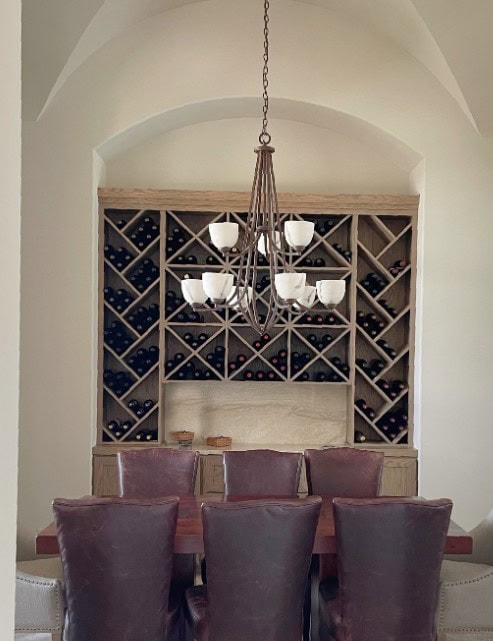 sherwin williams canvas tan, warm neutral paint color, vaulted ceiling, burgundy maroon leather dining chairs
